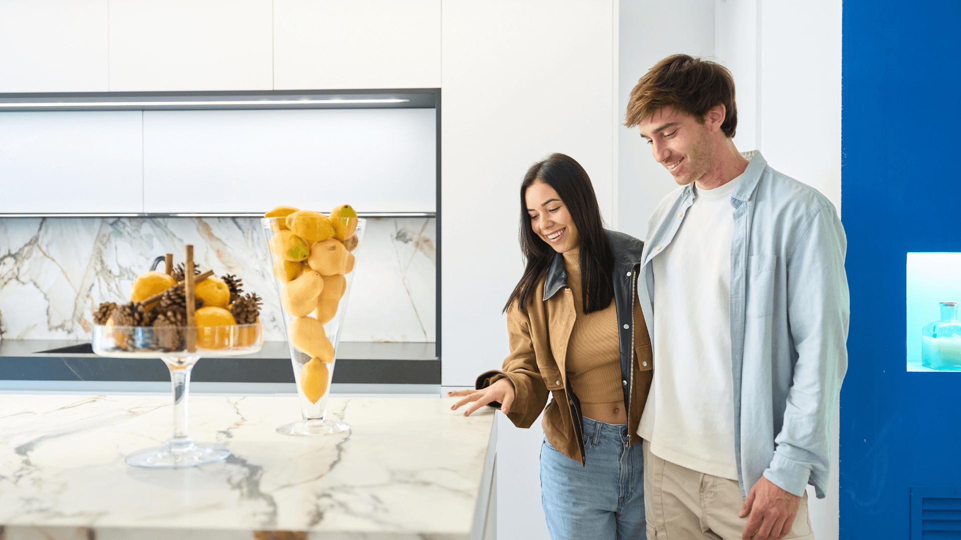 Couple visiting a new launch condo showflat, exploring the living spaces, floor plans and interior finishes.