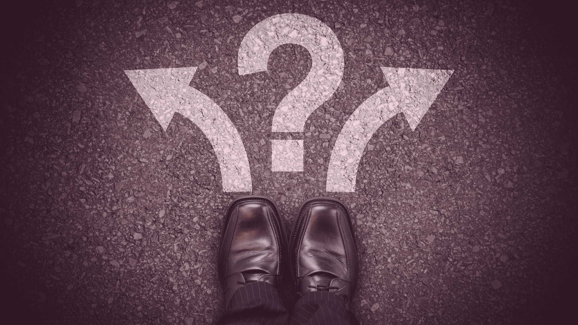Man’s foot standing at a fork in the road with arrows pointing left and right and a question mark, symbolising the decision between 2 difference new condo choices